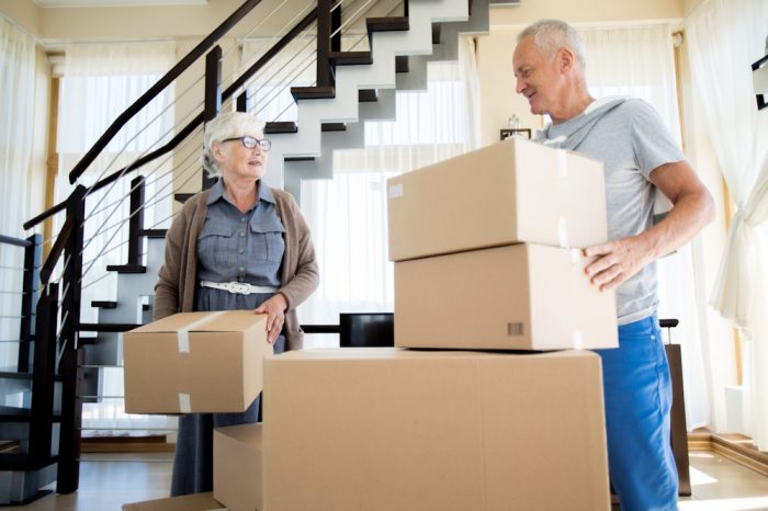 senior couple packing boxes